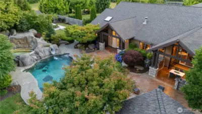 A dream backyard for swimming in the heated pool, slide, hot tub, and an amazing outdoor kitchen!