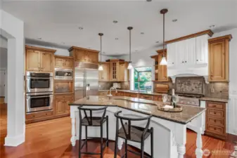 Gorgeous Granite tops and full height tile backsplash. All Stainless Steel appliances including a Sub Zero fridge, 6-Burner Range, double ovens. Love the "lazy River" veggie sink in the island!!!