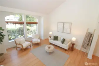Spacious living room with stunning arched window that floods the space with natural light.