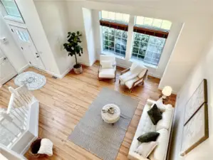 The heart of the home features dramatic two-story ceilings, beautiful architectural details, and perfect integration of living, dining, and kitchen spaces.