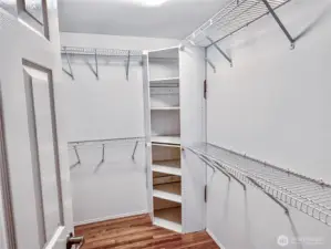 Generous walk-in closet with custom wire shelving system provides exceptional storage and organization for the primary suite.