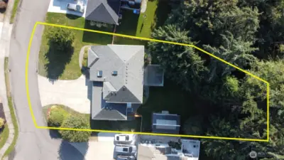 Spectacular aerial view showcases the impressive lot size, mature landscaping, and estimated property lines with pristine greenbelt wetlands providing ultimate privacy.