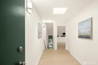Upstairs entry. New LVP flooring and white paint throughout.  Skylights bring the light in, and views of the lake in rear from both levels of the home.