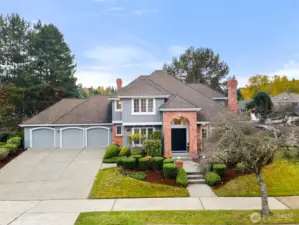 Elegant two-story Bellevue residence with manicured landscaping, brick accents, and expansive three-car garage.