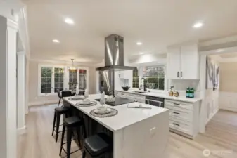 Expansive kitchen with oversized island, bar seating, and premium stainless appliances.