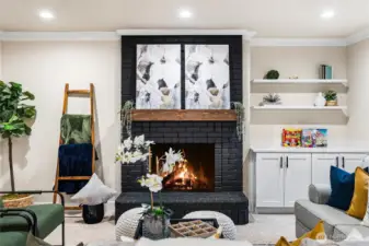 Fireplace focal point with custom surround and curated shelving details.