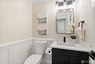 Stylish main-level powder room with modern vanity and updated finishes.