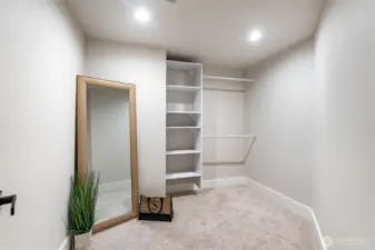 Large walk-in closet with built-in shelving and abundant storage.