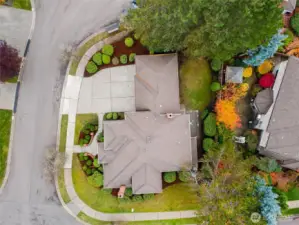 Aerial perspective highlighting corner lot positioning and mature landscaping.