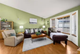 Vaulted ceilings and bay window create an open and inviting living space.
