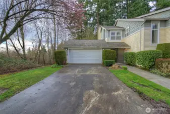 View from driveway to garage door. Park your car inside, stay dry and enter the home from an additional door.