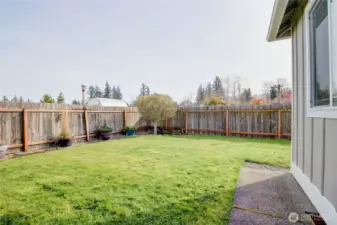 Middle yard of of back patio with privacy fence