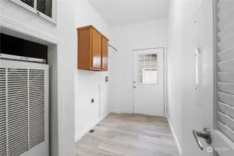 Functional utility room with side entrance to detached garage.