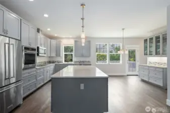 Kitchen has so many cabinets and pull out drawers.