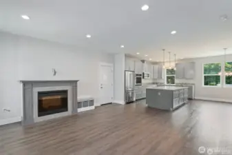 Entry leads right in to the great room area with living room, kitchen, and dining room.