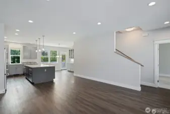 Living room looing towards the kitchen & dining room, with primary bedroom and staircase to the right.