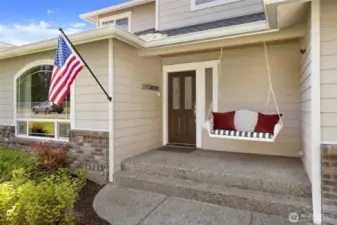 Spacious front patio w/swing bench welcomes you inside.