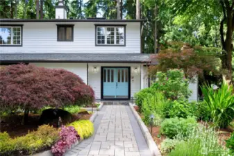 Flowers of various seasons are surrounding this house.