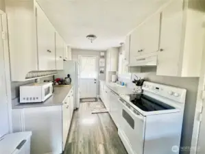 galley kitchen with a back door that exits into the