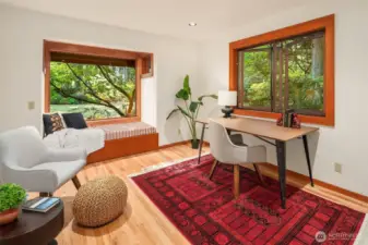 Main floor office/entertainment room with another window seat and built-in shelves.