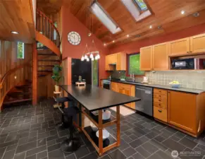 Kitchen has skylights, vaulted celiings, Richlite counter tops and an eating bar.