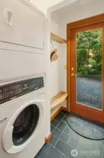 Mud entry back door with laundry and pantry shelves.