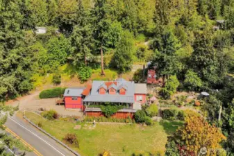 The 1.41 acre property features lush landscaping, a 560 square foot home, and a historic building