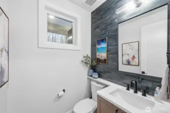Main floor half bath is stylish and functional.