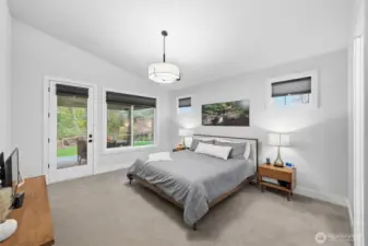 The primary suite opens to the covered patio and easily holds a king-sized bed and side tables.