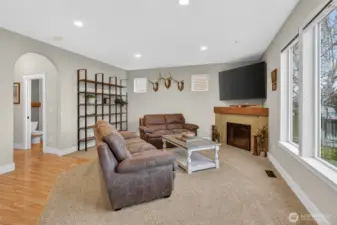 Large living room on main level with electric fireplace