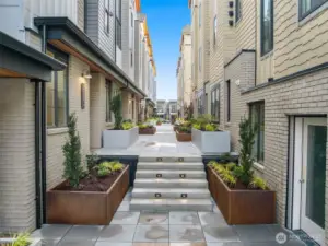 Discover the courtyard at Jackson & Elm—lined with modern brick facades, designer landscaping, and integrated lighting; this welcoming walkway is as stylish as it is functional. Every unit is nestled with purpose—balancing privacy, greenery, and walkability steps from all Kirkland offers.