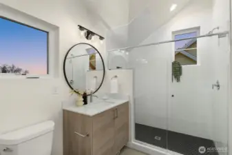 A bathroom that gets it. Skylit shower, matte black tile, and a feel that says "spa day" every day.