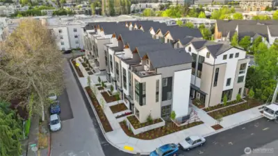 Get a bird's-eye view of the entire Jackson & Elm community—intentionally designed homes with private roof decks, sleek lines, and premium exterior detailing.