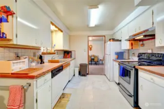 Galley kitchen leading to attached single car garage and utility closet! All appliances in the home and garage stay!
