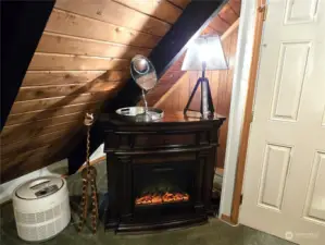 Cozy fireplace in the primary bedroom.