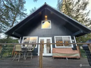 Looking up from yard to the deck on the rear of the home.