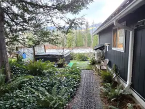 Nicely landscaped side yard with hot tub.