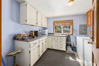 Main floor utility room with lots of cabinets & bright window to allow lots of light.