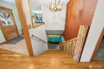 Staircase for the basement is located in the middle of the house between the kitchen & family room.