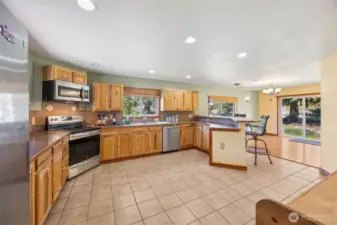 Nice sized kitchen with breakfast bar, stainless steel appliances, ceramic tile floors with lots of open spaces.