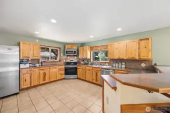 Large open kitchen with plenty of countertop & cabinet space. Two windows in the kitchen & one in the dining area allow light to flood these areas.