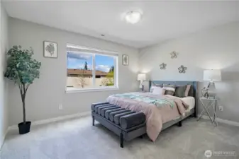 Bedroom 4: Grey queen size bed displayed and still has ample space