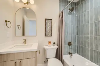 Full bath with tub/shower combo.