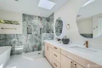 Another view of the primary bath with a dual sink vanity.
