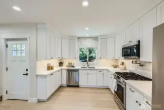 Stunning kitchen with white cabinetry and stainless appliances.
