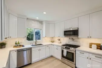Full height backsplash and under-cabinet lighting complement this kitchen.