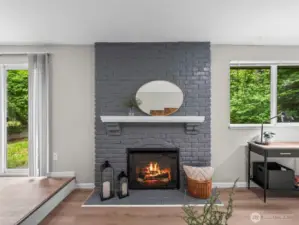 The grey brick fireplace gives a nod to modern color schemes. The electric fireplace produces heat as well as changes color for ambiance.