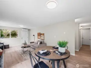 The dining space connects to the kitchen and hallway leading to the bedrooms as well as the bathroom and shared laundry room.