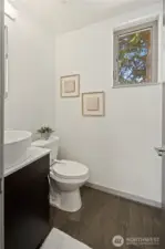 Half bath on level with kitchen, dining and living rooms