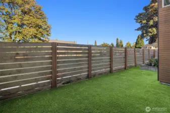 Fully fenced back yard with astroturf